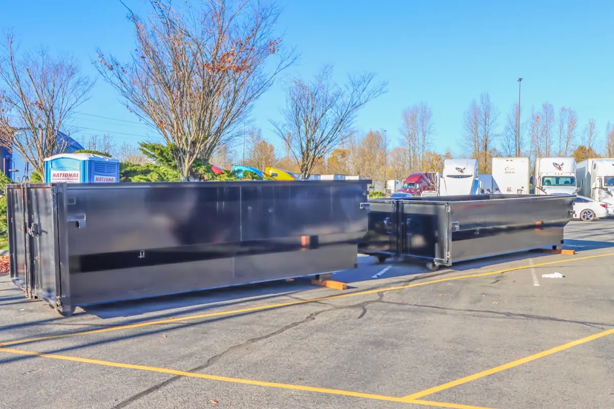 Professional dumpster rental service with roll-off container on residential driveway in Eureka